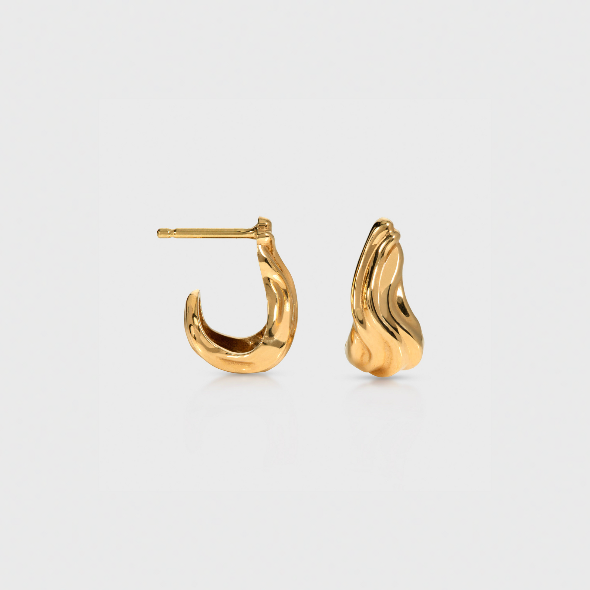 Gold hoop earrings on a light gray background