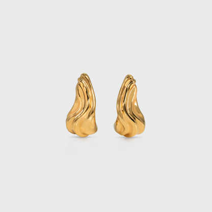 Pair of gold earrings on a light gray background