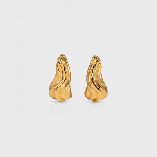 Pair of gold earrings on a light gray background